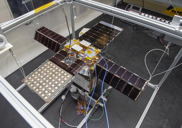 NASA image: Spacecraft in Gravity Off-load Fixture (GOLF), System Test configuration - Arisa Waddle – Test Engineer,  Rick Wilson – Lead Test Engineer