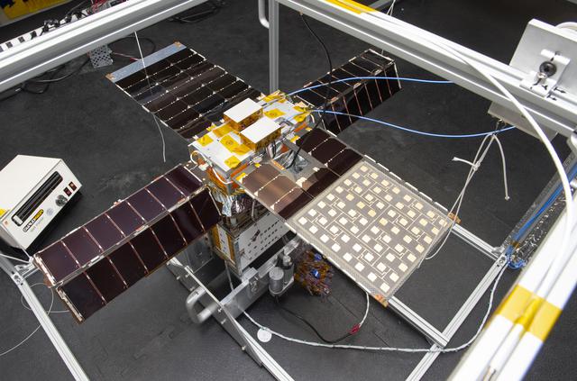 NASA image: Spacecraft in Gravity Off-load Fixture (GOLF), System Test configuration - Arisa Waddle – Test Engineer,  Rick Wilson – Lead Test Engineer