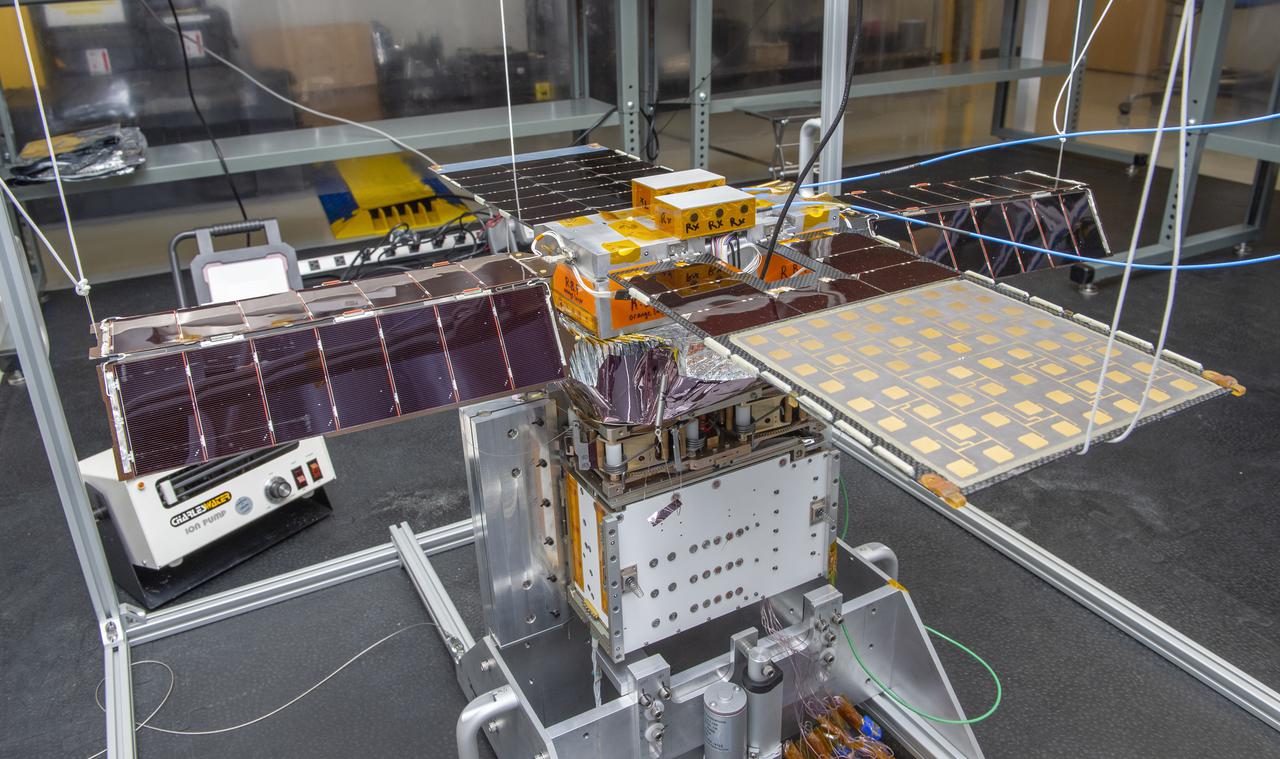 Spacecraft in Gravity Off-load Fixture (GOLF), System Test configuration - Arisa Waddle – Test Engineer,  Rick Wilson – Lead Test Engineer