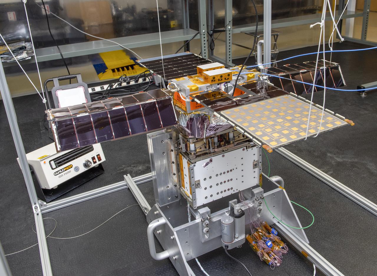 Spacecraft in Gravity Off-load Fixture (GOLF), System Test configuration - Arisa Waddle – Test Engineer,  Rick Wilson – Lead Test Engineer