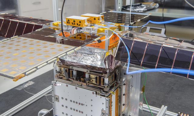 NASA image: Spacecraft in Gravity Off-load Fixture (GOLF), System Test configuration - Arisa Waddle – Test Engineer,  Rick Wilson – Lead Test Engineer