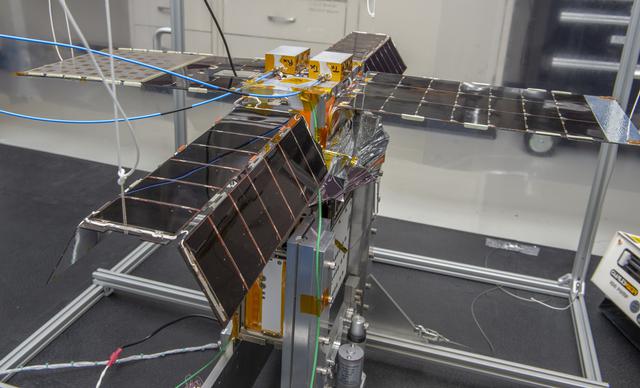 NASA image: Spacecraft in Gravity Off-load Fixture (GOLF), System Test configuration - Arisa Waddle – Test Engineer,  Rick Wilson – Lead Test Engineer