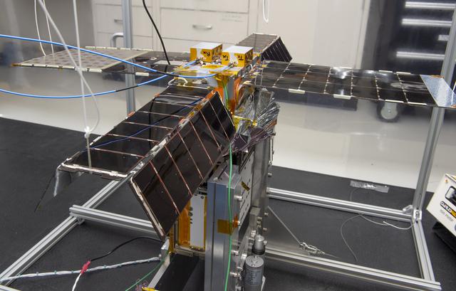 NASA image: Spacecraft in Gravity Off-load Fixture (GOLF), System Test configuration - Arisa Waddle – Test Engineer,  Rick Wilson – Lead Test Engineer