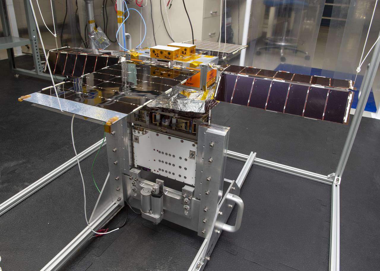 Spacecraft in Gravity Off-load Fixture (GOLF), System Test configuration - Arisa Waddle – Test Engineer,  Rick Wilson – Lead Test Engineer