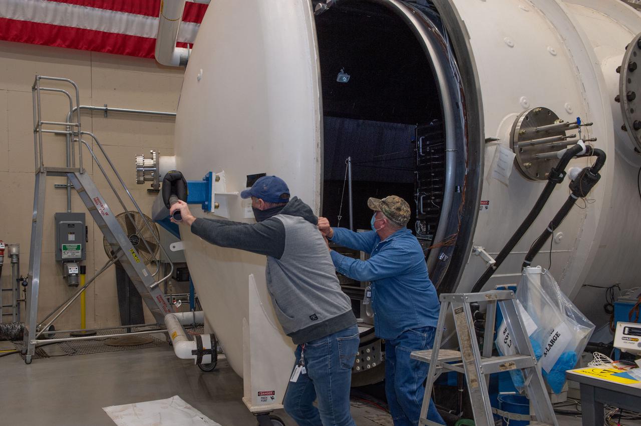 Opening Thermal Vacuum Chamber V15 to extract hot box containing NEA Scout spacecraft.