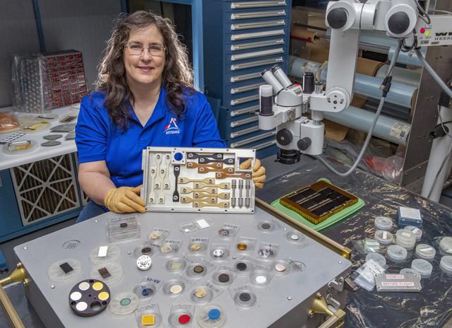 NASA image: Miria Finckenor, a researcher at NASA’s Marshall Space Flight Center in Huntsville, Alabama, shows off the 15th Materials International Space Station Experiment, or MISSE, an external science payload berthed on the International Space Station since 2001