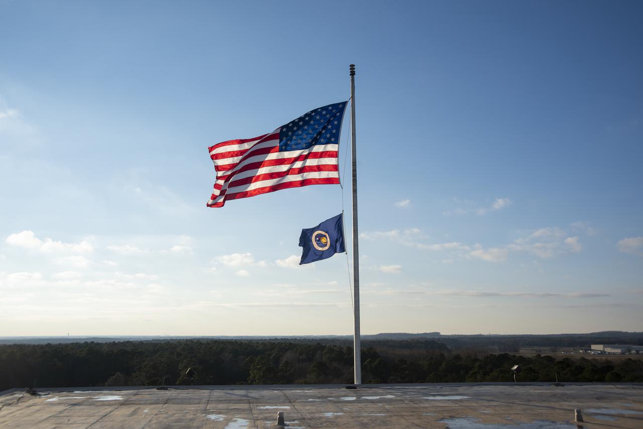 The U.S. and NASA flags atop Building 4200 at NASA Marshall Space Flight Center in Huntsville, Alabama, were retired Jan. 21, 2022. These images show center operations employees lowering the flags at Building 4200, which was Marshall’s original central laboratory and office building and served as Marshall’s headquarters since 1963. This building will be demolished later this year. A flag-raising ceremony marking the transfer of Marshall headquarters to Building 4221 was held Jan. 26, 2022. The doors to Building 4221 opened on Earth Day, April 22, 2019.