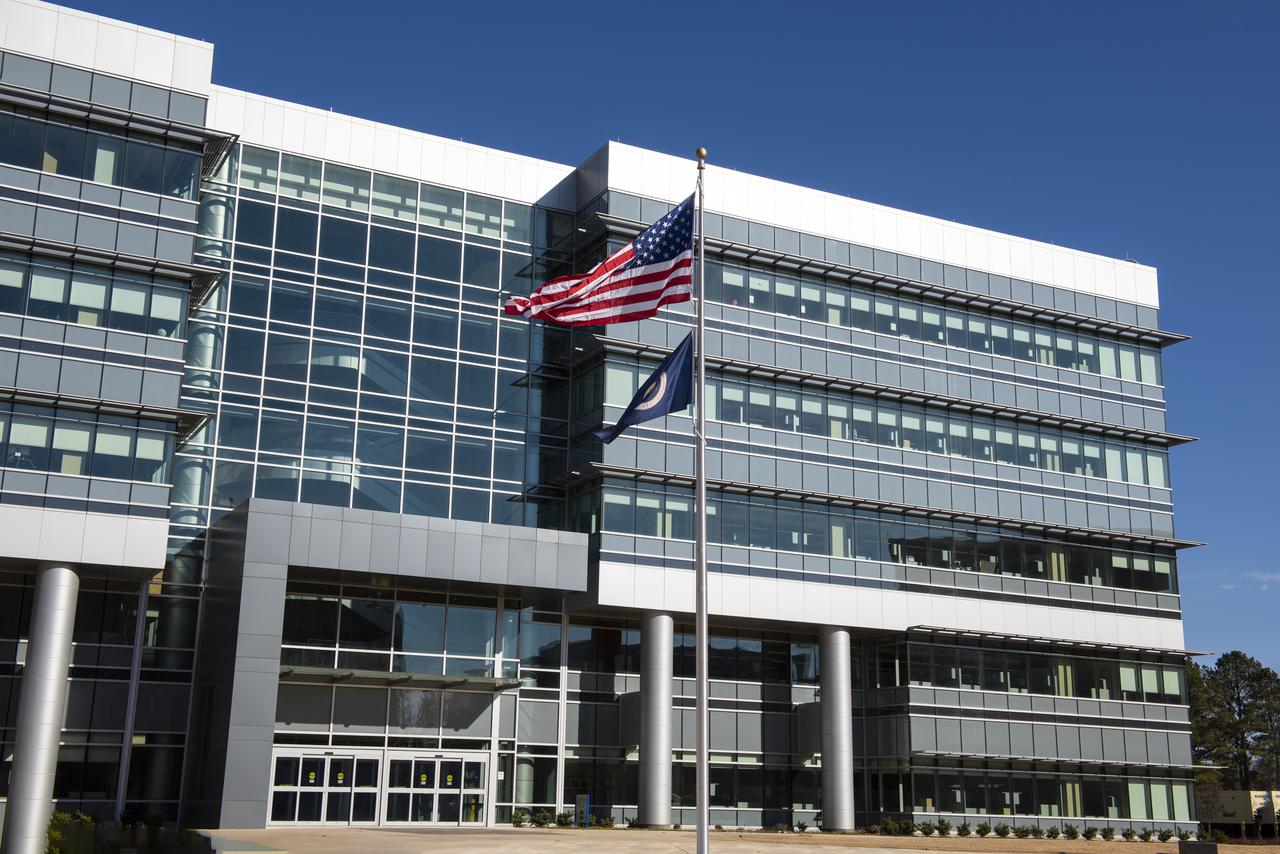 On Jan. 26, 2022, the U.S. and NASA flags were raised at Building 4221 to mark the transfer of headquarters to that building at Marshall Space Flight Center in Huntsville, Alabama. The doors to Building 4221, a new, environmentally friendly building, opened on Earth Day, April 22, 2019. Building 4200 served as Marshall’s original headquarters  since 1963. Marshall center operations lowered flags at that building on Jan. 21, 2022.