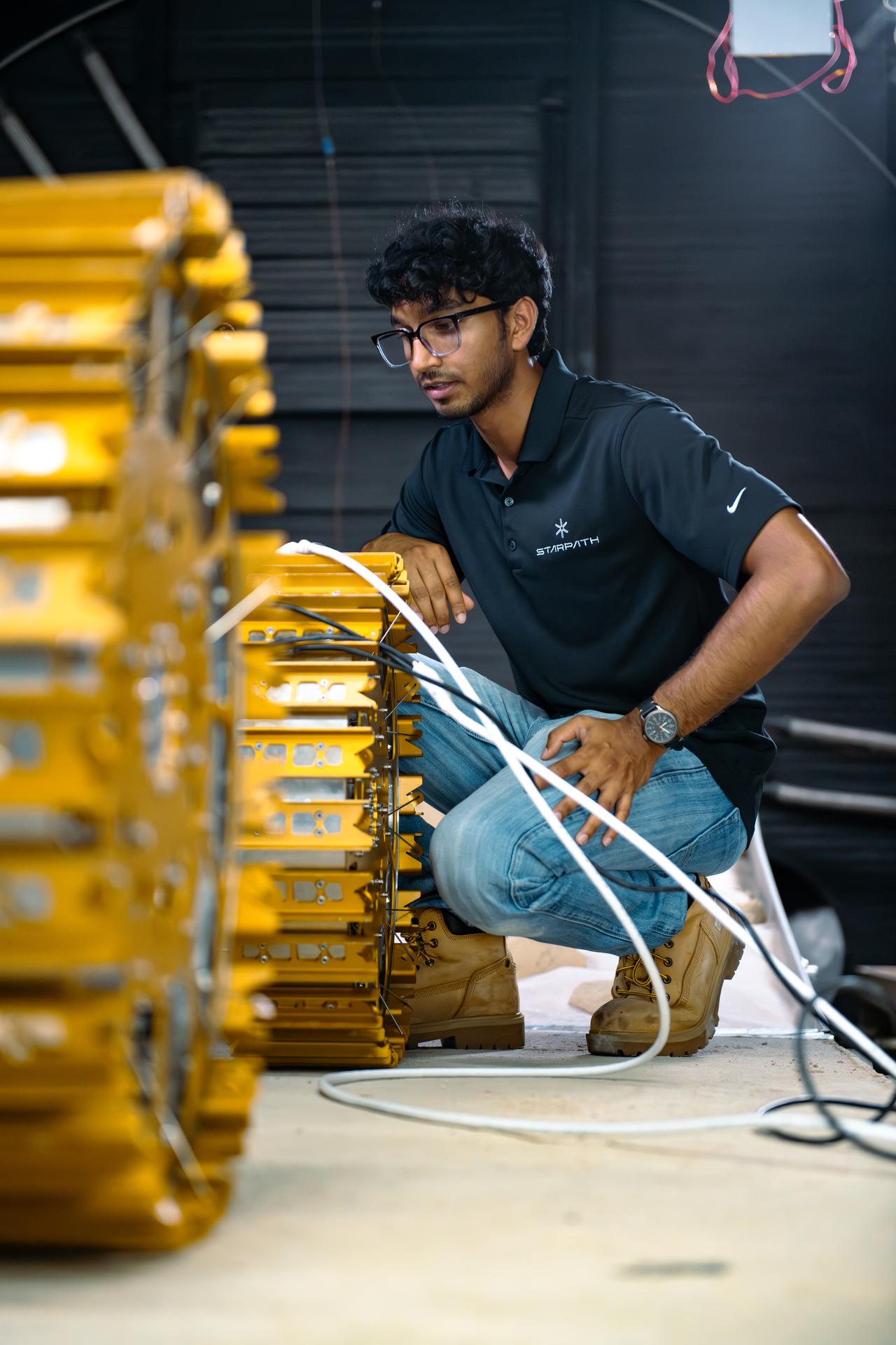 Starpath mechanical engineer Josh Kavilaveettil monitors a component of the rover, attached to wires, in preparation for testing at NASA’s Marshall Space Flight Center in Huntsville, Alabama on July 30, 2025. The technology startup headquartered in Hawthorne, California, won second place overall at the agency’s Break the Ice Lunar Challenge’s live demonstration and finale in June 2024. This competition, one of NASA’s Centennial Challenges, tasked competitors to design, build, and demonstrate robotic technologies that could excavate and transport the icy, rocky dirt – otherwise known as regolith – found on the Moon. Starpath’s visit to NASA Marshall was part of their prize opportunity to test their upgraded lunar regolith excavation and transportation rover in the center’s 20-foot thermal vacuum chamber.  For more information, contact NASA Marshall’s Office of Communications at 256-544-0034.