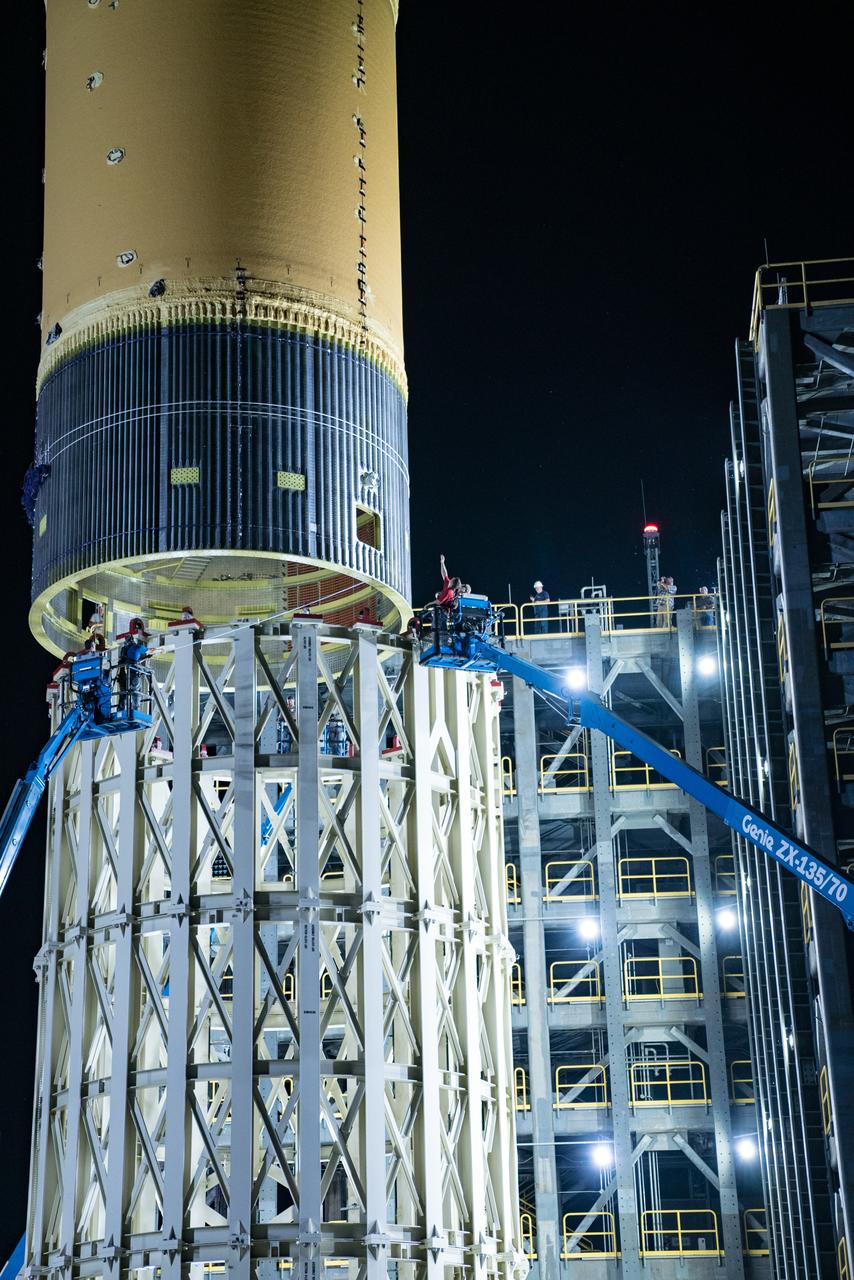 This collection of photos shows the steps NASA engineers took to lift the final structural test article for NASA’s Space Launch System (SLS) core stage into Test Stand 4697 at NASA’s Marshall Space Flight Center in Huntsville, Alabama, July 10, 2019. The liquid oxygen (LOX) tank is one of two propellant tanks in the rocket’s massive core stage that will produce more than 2 million pounds of thrust to help launch Artemis 1, the first flight of NASA’s Orion spacecraft and SLS, to the Moon. The nearly 70-foot-long liquid oxygen tank structural test article was manufactured at NASA’s Michoud Assembly Facility in New Orleans and delivered by NASA’s barge Pegasus to Marshall. Once bolted into the test stand, dozens of hydraulic cylinders will push and pull the tank, subjecting it to the same stresses and forces it will endure during liftoff and flight, to verify it is fit for flight.