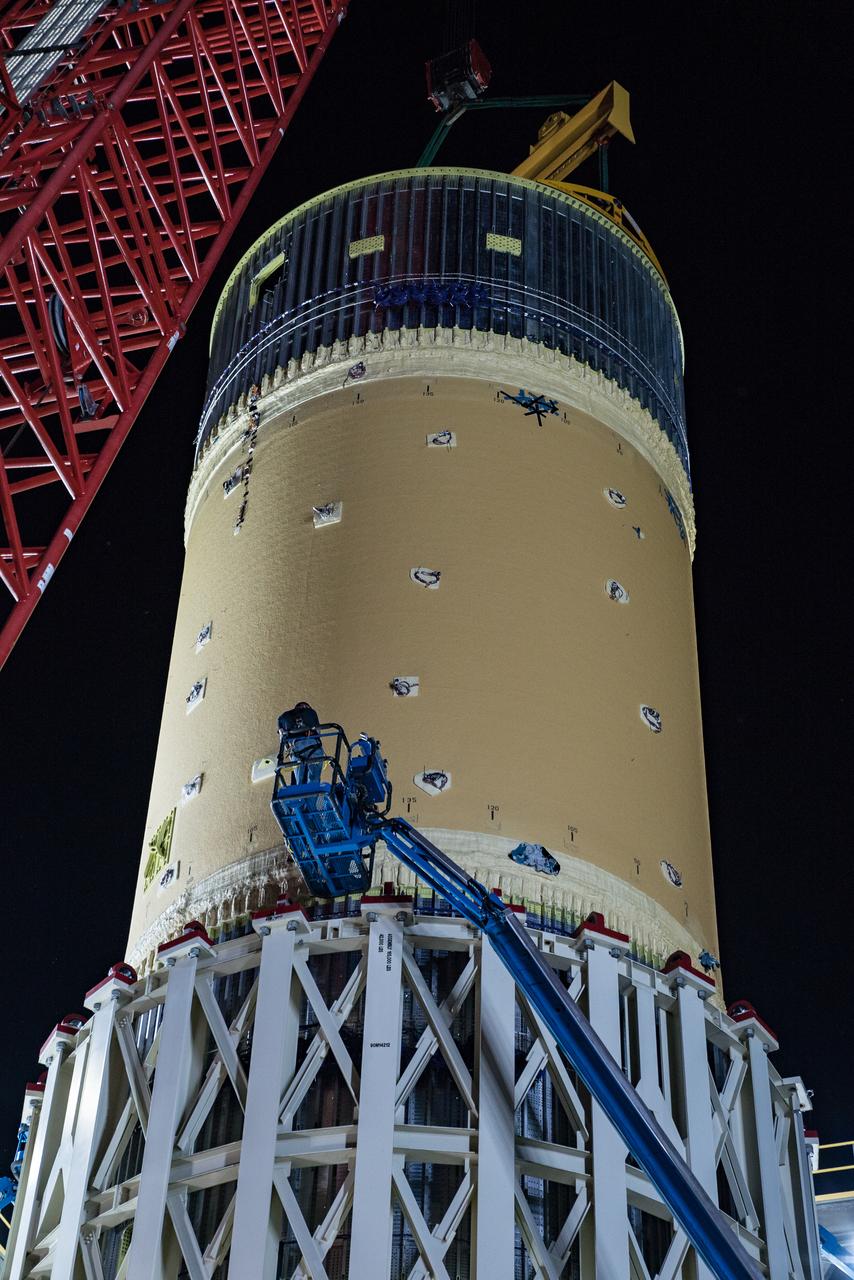 This collection of photos shows the steps NASA engineers took to lift the final structural test article for NASA’s Space Launch System (SLS) core stage into Test Stand 4697 at NASA’s Marshall Space Flight Center in Huntsville, Alabama, July 10, 2019. The liquid oxygen (LOX) tank is one of two propellant tanks in the rocket’s massive core stage that will produce more than 2 million pounds of thrust to help launch Artemis 1, the first flight of NASA’s Orion spacecraft and SLS, to the Moon. The nearly 70-foot-long liquid oxygen tank structural test article was manufactured at NASA’s Michoud Assembly Facility in New Orleans and delivered by NASA’s barge Pegasus to Marshall. Once bolted into the test stand, dozens of hydraulic cylinders will push and pull the tank, subjecting it to the same stresses and forces it will endure during liftoff and flight, to verify it is fit for flight.
