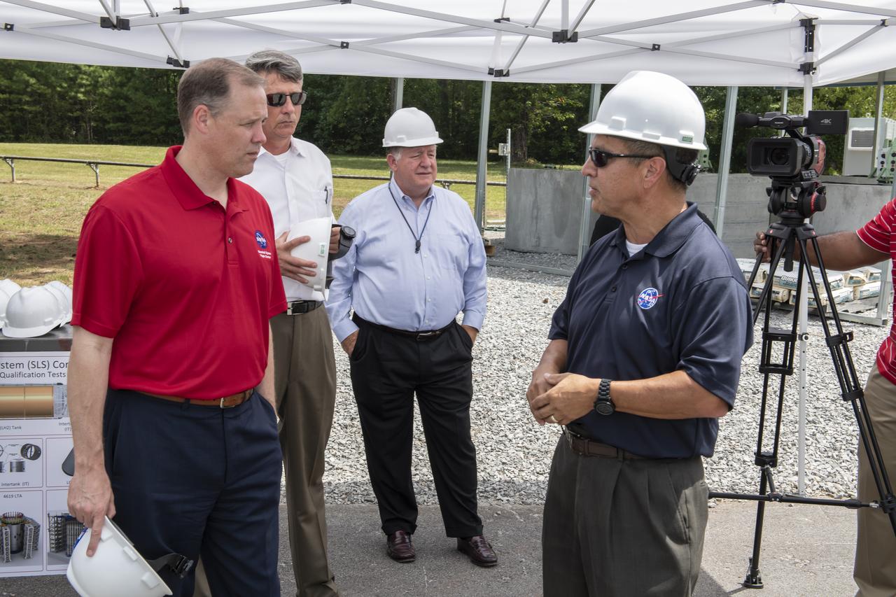 On August 15, 2018 NASA Administrator Jim Bridenstine visited Marshall Space Flight Center. Upon his arrival he was greeted by MSFC Acting Director Jody Singer along with the senior management team. From atop Marshallâ€™s Test Stand 4693, NASA Administrator Jim Bridenstine and SLS Stages Integration Manager Tim Flores discuss the capabilities of Marshallâ€™s newest test stand. The qualification test version of the liquid hydrogen tank for the Space Launch Systemâ€™s core stage will be positioned between the standâ€™s 221-foot-tall twin towers where it will be pushed, pulled and subjected to the stresses it will endure during liftoff and flight.