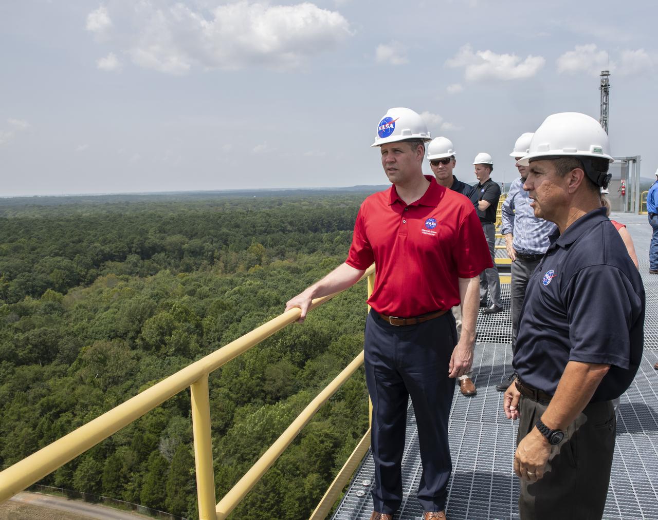 On August 15, 2018 NASA Administrator Jim Bridenstine visited Marshall Space Flight Center. Upon his arrival he was greeted by MSFC Acting Director Jody Singer along with the senior management team. From atop Marshall’s Test Stand 4693, NASA Administrator Jim Bridenstine and SLS Stages Integration Manager Tim Flores discuss the capabilities of Marshall’s newest test stand. The qualification test version of the liquid hydrogen tank for the Space Launch System’s core stage will be positioned between the stand’s 221-foot-tall twin towers where it will be pushed, pulled and subjected to the stresses it will endure during liftoff and flight.