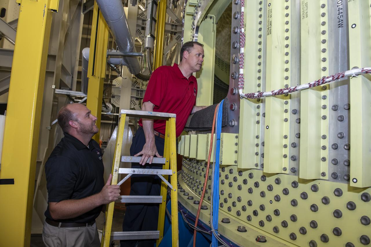 On August 15, 2018 NASA Administrator Jim Bridenstine visited Marshall Space Flight Center. Upon his arrival he was greeted by MSFC Acting Director Jody Singer along with the senior management team. Lead test engineer for the Space Launch System core stage intertank, Matt Cash briefs NASA Administrator Jim Bridenstine on testing progress of the SLS test article in the Structural Strength Lab at Marshall. The test article is structurally identical to the flight version of the intertank that will connect the core stage's two colossal fuel tanks, serve as the upper-connection point for the two solid rocket boosters and house critical avionics and electronics.