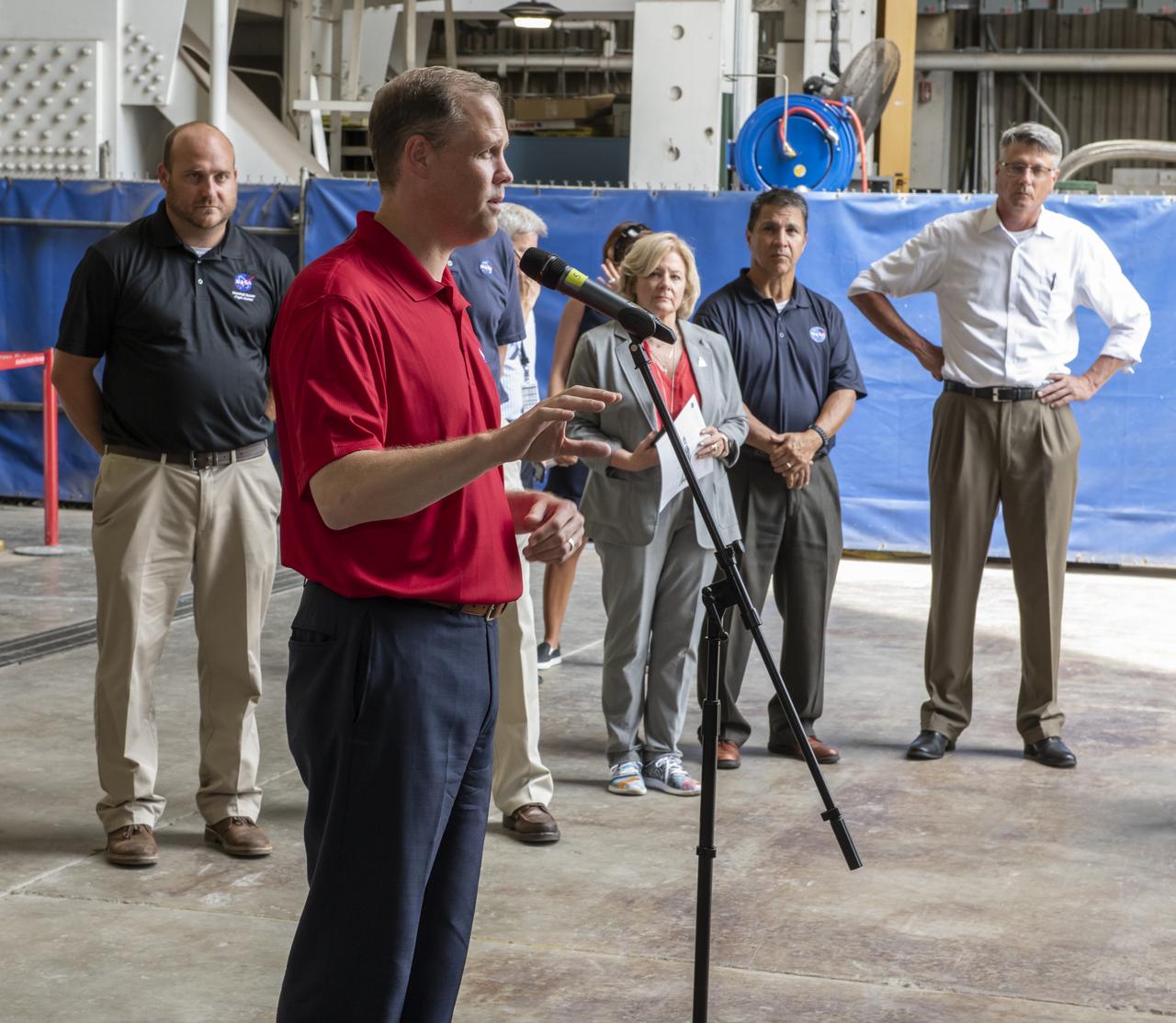 On August 15, 2018 NASA Administrator Jim Bridenstine visited Marshall Space Flight Center. Upon his arrival he was greeted by MSFC Acting Director Jody Singer along with the senior management team.  NASA Administrator Jim Bridenstine addresses the media about the progress of the Space Launch System development and testing during a question-and-answer session in front of the SLS intertank test article at Marshall. SLS, which is managed by Marshall, will enable a new era of exploration beyond Earth's orbit by launching astronauts on missions to deep space destinations including the Moon and Mars.