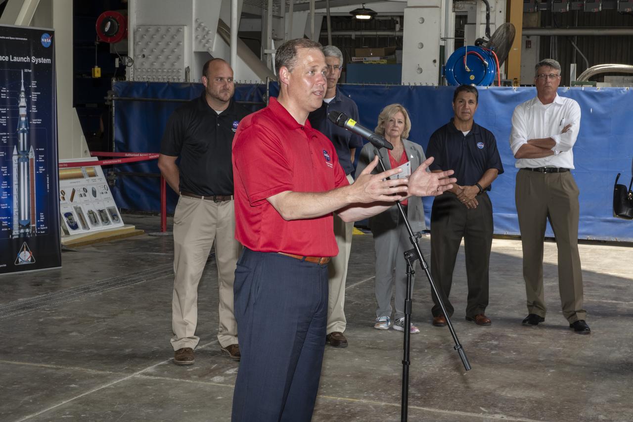 On August 15, 2018 NASA Administrator Jim Bridenstine visited Marshall Space Flight Center. Upon his arrival he was greeted by MSFC Acting Director Jody Singer along with the senior management team.  NASA Administrator Jim Bridenstine addresses the media about the progress of the Space Launch System development and testing during a question-and-answer session in front of the SLS intertank test article at Marshall. SLS, which is managed by Marshall, will enable a new era of exploration beyond Earth's orbit by launching astronauts on missions to deep space destinations including the Moon and Mars.