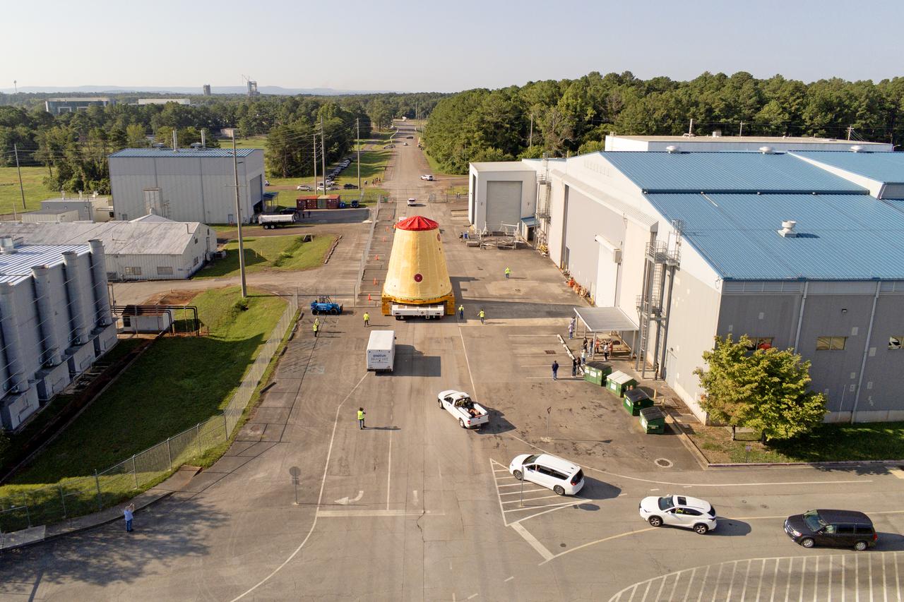 NASA rolled out a key piece of space flight hardware for the SLS (Space Launch System) rocket for the first crewed mission of NASA’s Artemis campaign from Marshall Space Flight Center in Huntsville, Alabama, on Wednesday, Aug. 21 for shipment to the agency’s spaceport in Florida. The cone-shaped launch vehicle stage adapter connects the rocket’s core stage to the upper stage and helps protect the upper stage’s engine that will help propel the Artemis II test flight around the Moon, slated for 2025. Manufactured by prime contractor Teledyne Brown Engineering and the Jacobs Space Exploration Group’s ESSCA (Engineering Services and Science Capability Augmentation) contract using NASA Marshall’s self-reacting friction-stir robotic and vertical weld tools. Crews moved the adapter out of NASA Marshall’s Building 4708 to the agency’s Pegasus barge Aug. 21. The barge will ferry the adapter first to NASA’s Michoud Assembly Facility in New Orleans, where crews will pick up additional SLS hardware for future Artemis missions, before traveling to NASA Kennedy. Once in Florida, the adapter will join the recently delivered core stage. There, teams with NASA’s Exploration Ground Systems will prepare the adapter for stacking and launch.