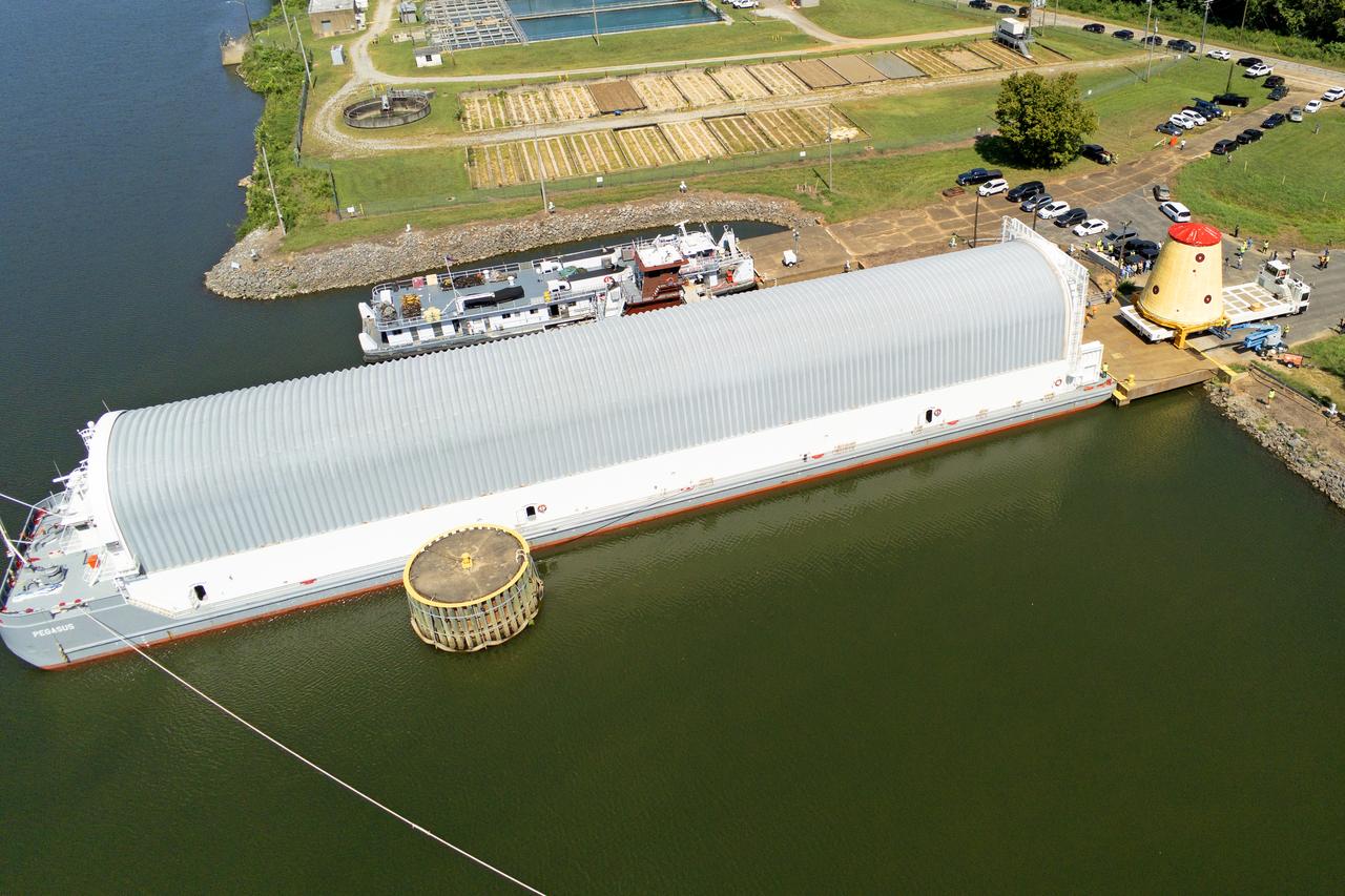 These images and videos show NASA rolling out a key piece of space flight hardware for the SLS (Space Launch System) rocket for the first crewed mission of NASA’s Artemis campaign from Marshall Space Flight Center in Huntsville, Alabama, on Wednesday, Aug. 21 for shipment to the agency’s spaceport in Florida. The cone-shaped launch vehicle stage adapter connects the rocket’s core stage to the upper stage and helps protect the upper stage’s engine that will help propel the Artemis II test flight around the Moon, slated for 2025. Manufactured by prime contractor Teledyne Brown Engineering and the Jacobs Space Exploration Group’s ESSCA (Engineering Services and Science Capability Augmentation) contract using NASA Marshall’s self-reacting friction-stir robotic and vertical weld tools. Crews moved the adapter out of NASA Marshall’s Building 4708 to the agency’s Pegasus barge Aug. 21. The barge will ferry the adapter first to NASA’s Michoud Assembly Facility in New Orleans, where crews will pick up additional SLS hardware for future Artemis missions, before traveling to NASA Kennedy. Once in Florida, the adapter will join the recently delivered core stage. There, teams with NASA’s Exploration Ground Systems will prepare the adapter for stacking and launch.