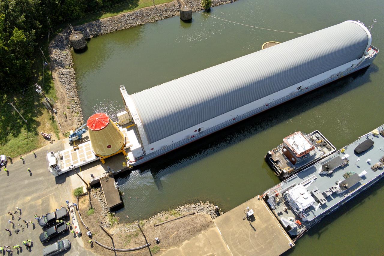 NASA rolled out a key piece of space flight hardware for the SLS (Space Launch System) rocket for the first crewed mission of NASA’s Artemis campaign from Marshall Space Flight Center in Huntsville, Alabama, on Wednesday, Aug. 21 for shipment to the agency’s spaceport in Florida. The cone-shaped launch vehicle stage adapter connects the rocket’s core stage to the upper stage and helps protect the upper stage’s engine that will help propel the Artemis II test flight around the Moon, slated for 2025. Manufactured by prime contractor Teledyne Brown Engineering and the Jacobs Space Exploration Group’s ESSCA (Engineering Services and Science Capability Augmentation) contract using NASA Marshall’s self-reacting friction-stir robotic and vertical weld tools. Crews moved the adapter out of NASA Marshall’s Building 4708 to the agency’s Pegasus barge Aug. 21. The barge will ferry the adapter first to NASA’s Michoud Assembly Facility in New Orleans, where crews will pick up additional SLS hardware for future Artemis missions, before traveling to NASA Kennedy. Once in Florida, the adapter will join the recently delivered core stage. There, teams with NASA’s Exploration Ground Systems will prepare the adapter for stacking and launch.