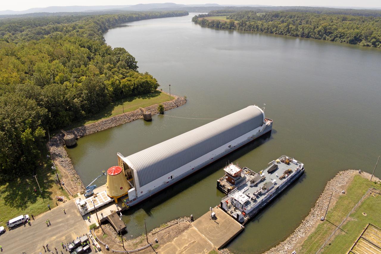 NASA rolled out a key piece of space flight hardware for the SLS (Space Launch System) rocket for the first crewed mission of NASA’s Artemis campaign from Marshall Space Flight Center in Huntsville, Alabama, on Wednesday, Aug. 21 for shipment to the agency’s spaceport in Florida. The cone-shaped launch vehicle stage adapter connects the rocket’s core stage to the upper stage and helps protect the upper stage’s engine that will help propel the Artemis II test flight around the Moon, slated for 2025. Manufactured by prime contractor Teledyne Brown Engineering and the Jacobs Space Exploration Group’s ESSCA (Engineering Services and Science Capability Augmentation) contract using NASA Marshall’s self-reacting friction-stir robotic and vertical weld tools. Crews moved the adapter out of NASA Marshall’s Building 4708 to the agency’s Pegasus barge Aug. 21. The barge will ferry the adapter first to NASA’s Michoud Assembly Facility in New Orleans, where crews will pick up additional SLS hardware for future Artemis missions, before traveling to NASA Kennedy. Once in Florida, the adapter will join the recently delivered core stage. There, teams with NASA’s Exploration Ground Systems will prepare the adapter for stacking and launch.