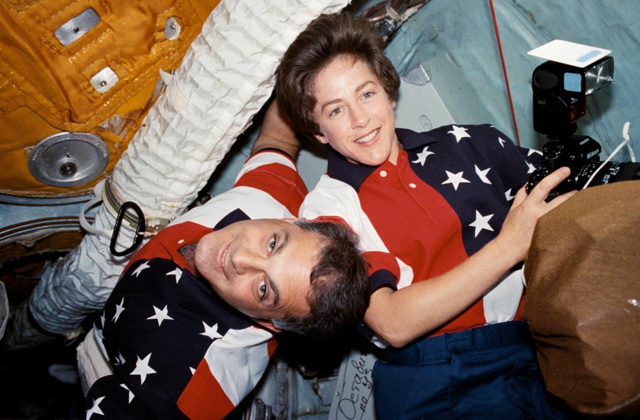 NASA5-328-030 (25 Sept.-6 Oct. 1997) --- Astronauts David A. Wolf and Wendy B. Lawrence, mission specialists, are pictured in the Docking Module (DM) between the Russia&#0146;s Mir Space Station and the Space Shuttle Atlantis, in early moments of joint activities between the STS-86 and Mir-24 crews. The photograph was taken with the camera used by astronaut C. Michael Foale, cosmonaut guest researcher, during his four-month stay aboard Mir. Wolf later replaced Foale as cosmonaut guest researcher on the Mir-24 crew.