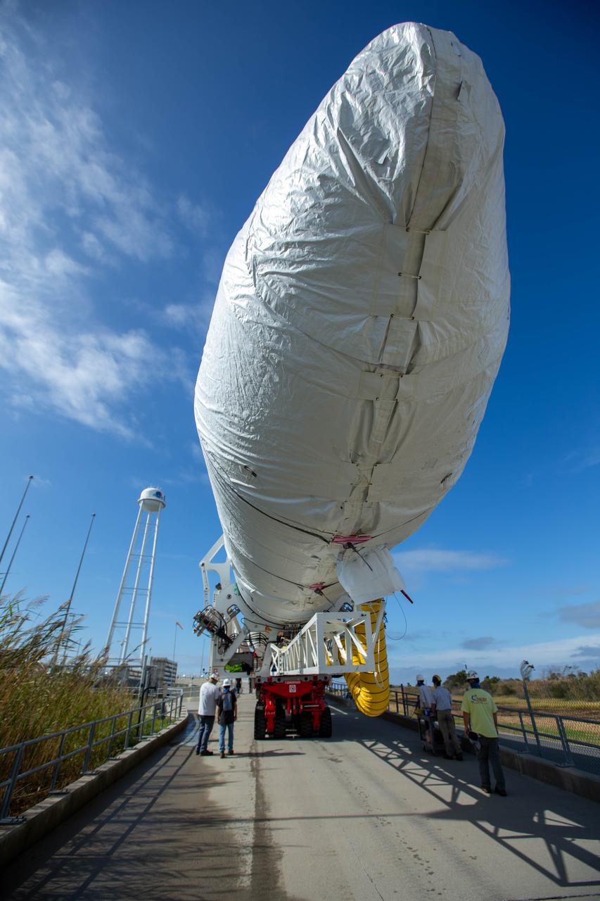 A Northrop Grumman Antares rocket carrying a Cygnus resupply spacecraft is seen as it is rolled out of the Horizontal Integration Facility to the Mid-Atlantic Regional Spaceport’s Pad-0A, Saturday, September 26, 2020, at NASA's Wallops Flight Facility in Virginia. Northrop Grumman’s 14th contracted cargo resupply mission with NASA to the International Space Station will deliver about 8,000 pounds of science and research, crew supplies and vehicle hardware to the orbital laboratory and its crew. The CRS-14 Cygnus spacecraft is named after the first female astronaut of Indian descent, Kaplana Chawla, and is scheduled to launch at 10:27 p.m., Tuesday, September 29, 2020 EDT. Photo Credit: (NASA/Patrick Black) 