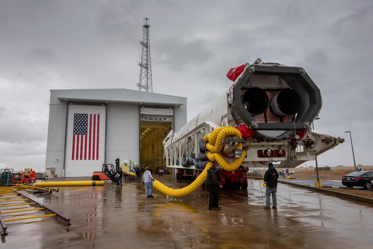 A Northrop Grumman Antares rocket carrying a Cygnus resupply spacecraft is seen as it is rolled out of the Horizontal Integration Facility on its way to the Mid-Atlantic Regional Spaceport’s Pad-0A, Tuesday, Feb. 16, 2021, at NASA's Wallops Flight Facility in Virginia. Northrop Grumman’s 15th contracted cargo resupply mission with NASA to the International Space Station will deliver about 8,000 pounds of science and research, crew supplies and vehicle hardware to the orbital laboratory and its crew. The CRS-15 Cygnus spacecraft is named after NASA mathematician, Katherine Johnson, a Black woman who time and again broke through barriers of gender and race. The launch is scheduled for 12:36 p.m. EST, Feb. 20, 2021. Photo Credit: (NASA/Patrick Black)