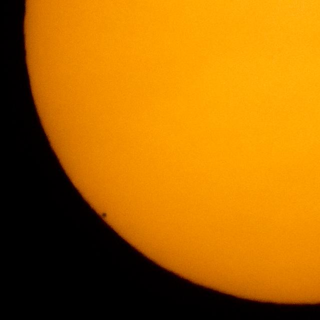 The planet Mercury is seen in silhouette, lower left of image, as it transits across the face of the sun, Monday, May 9, 2016, as viewed from Boyertown, Pennsylvania.  Mercury passes between Earth and the sun only about 13 times a century, with the previous transit taking place in 2006.  Photo Credit: (NASA/Bill Ingalls)