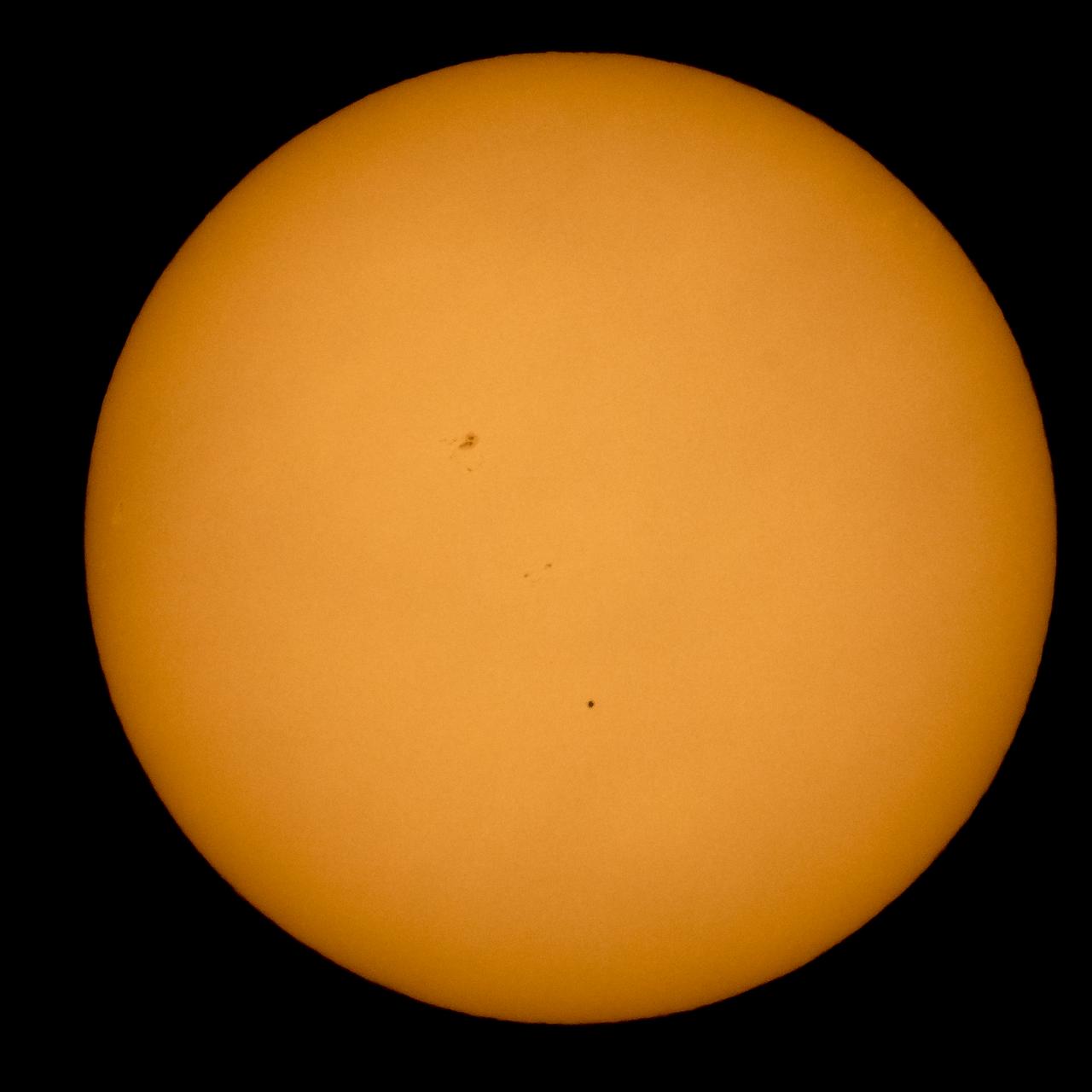 The planet Mercury is seen in silhouette, lower center of image, as it transits across the face of the sun, Monday, May 9, 2016, as viewed from Boyertown, Pennsylvania.  Mercury passes between Earth and the sun only about 13 times a century, with the previous transit taking place in 2006.  Photo Credit: (NASA/Bill Ingalls)