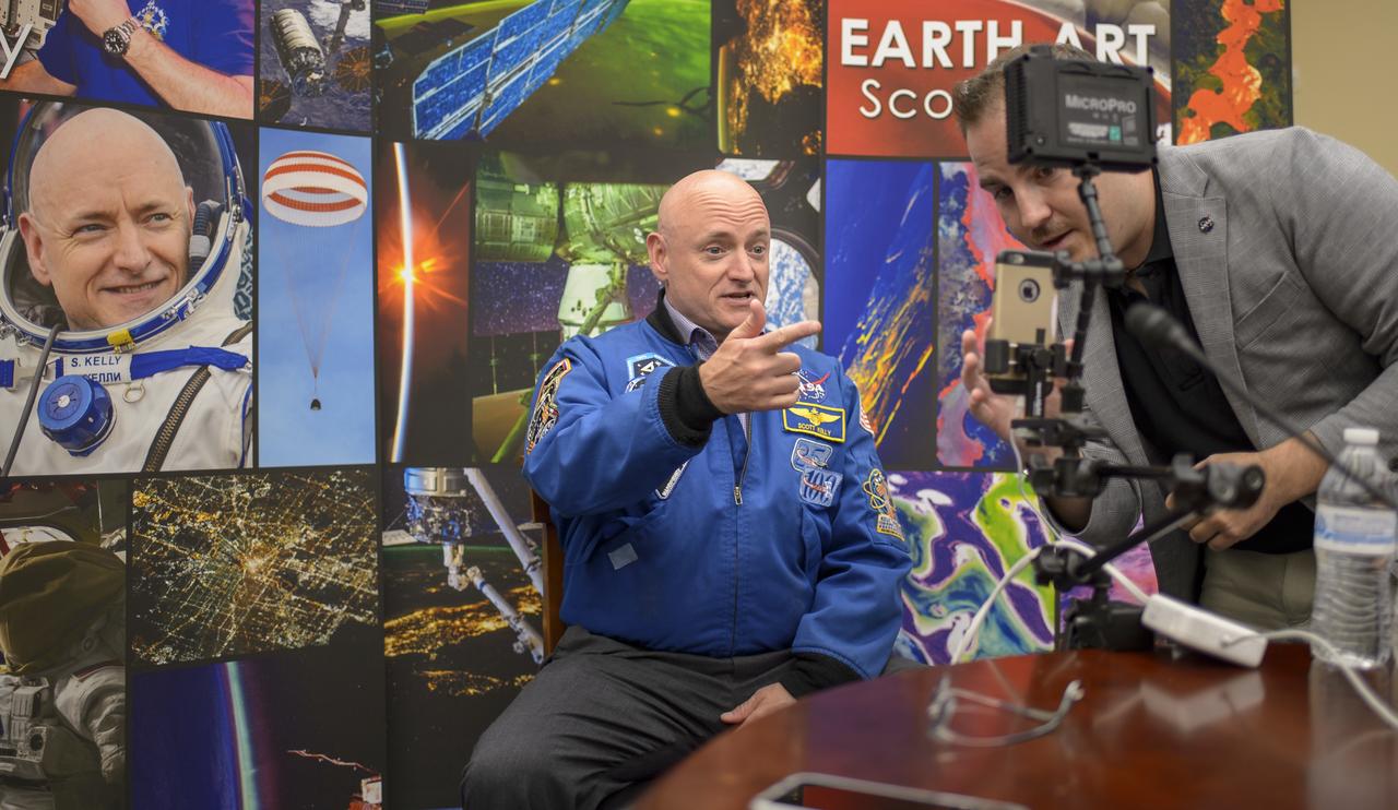 Former NASA astronaut Scott Kelly, left, gives video replies to questions from social media, Wednesday, May 25, 2016, in Washington. Photo Credit: (NASA/Bill Ingalls)