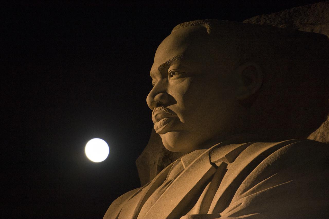 The moon, or supermoon, is seen as it sets over the Martin Luther King Jr. Memorial on Monday, Nov. 14, 2016. A supermoon occurs when the moon’s orbit is closest (perigee) to Earth. Early Monday morning, the moon was the closest it has been to Earth since 1948 and it appeared 30 percent brighter and 14 percent bigger than the average monthly full moon. Photo Credit: (NASA/Aubrey Gemignani)