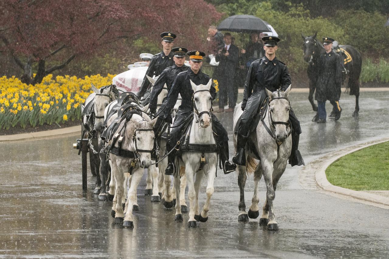 A horse drawn caisson carries former astronaut and U.S. Senator John Glenn to his final resting place during the interment ceremony at Arlington National Cemetery on Thursday, April 6, 2017 in Virginia. Glenn was the first American to orbit Earth on Feb. 20, 1962, in a five-hour flight aboard the Friendship 7 spacecraft. In 1998, he broke another record by returning to space at the age of 77 on the Space Shuttle Discovery. Photo Credit: (NASA/Aubrey Gemignani)