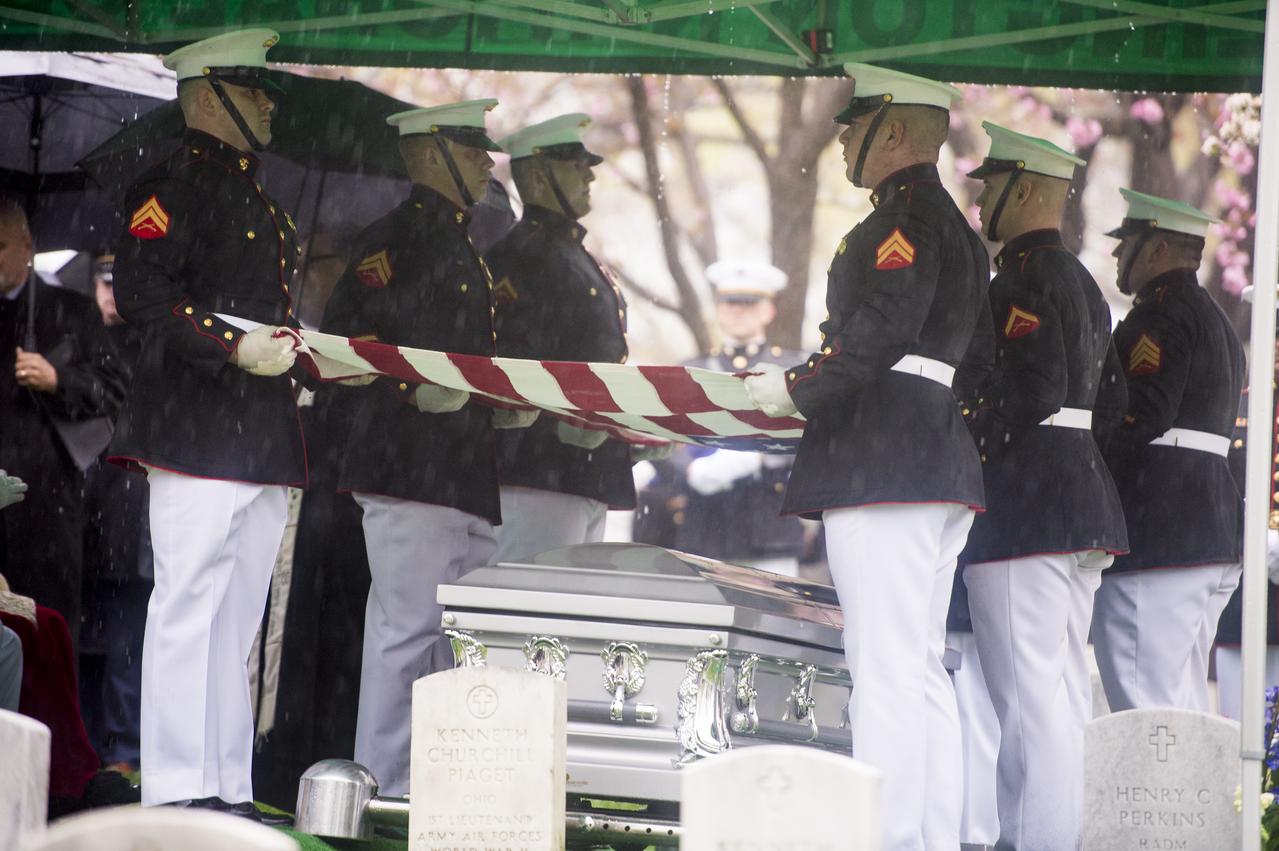 A Marine Corps honor guard holds the American flag over the casket of former astronaut and U.S. Senator John Glenn, who was buried with full military honors, at Arlington National Cemetery in Virginia on Thursday, April 6, 2017, the day on which he and his wife Annie were married in 1943. Glenn was the first American to orbit Earth on Feb. 20, 1962, in a five-hour flight aboard the Friendship 7 spacecraft. In 1998, he broke another record by returning to space at the age of 77 on the Space Shuttle Discovery. Photo Credit: (NASA/Aubrey Gemignani)