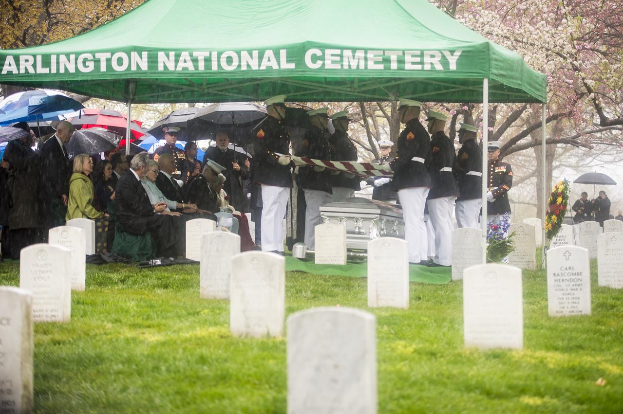 A Marine Corps honor guard holds the American flag over the casket of former astronaut and U.S. Senator John Glenn, who was buried with full military honors, at Arlington National Cemetery in Virginia on Thursday, April 6, 2017, the day on which he and his wife Annie were married in 1943. Glenn was the first American to orbit Earth on Feb. 20, 1962, in a five-hour flight aboard the Friendship 7 spacecraft. In 1998, he broke another record by returning to space at the age of 77 on the Space Shuttle Discovery. Photo Credit: (NASA/Aubrey Gemignani)