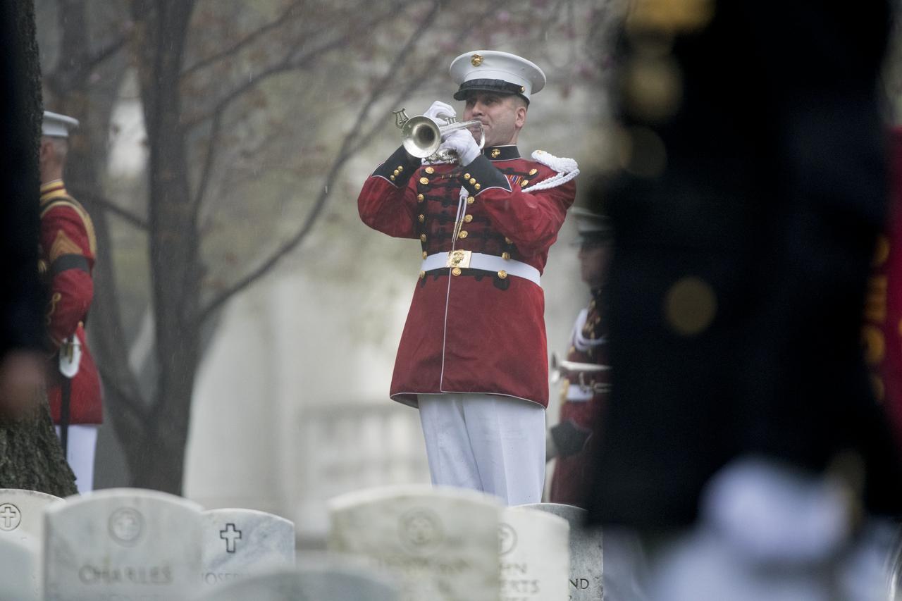 "Taps" is played during the funeral service for former astronaut and U.S. Senator John Glenn, who was buried with full military honors, at Arlington National Cemetery in Virginia on Thursday, April 6, 2017, the day on which he and his wife Annie were married in 1943. Glenn was the first American to orbit Earth on Feb. 20, 1962, in a five-hour flight aboard the Friendship 7 spacecraft. In 1998, he broke another record by returning to space at the age of 77 on the Space Shuttle Discovery. Photo Credit: (NASA/Aubrey Gemignani)