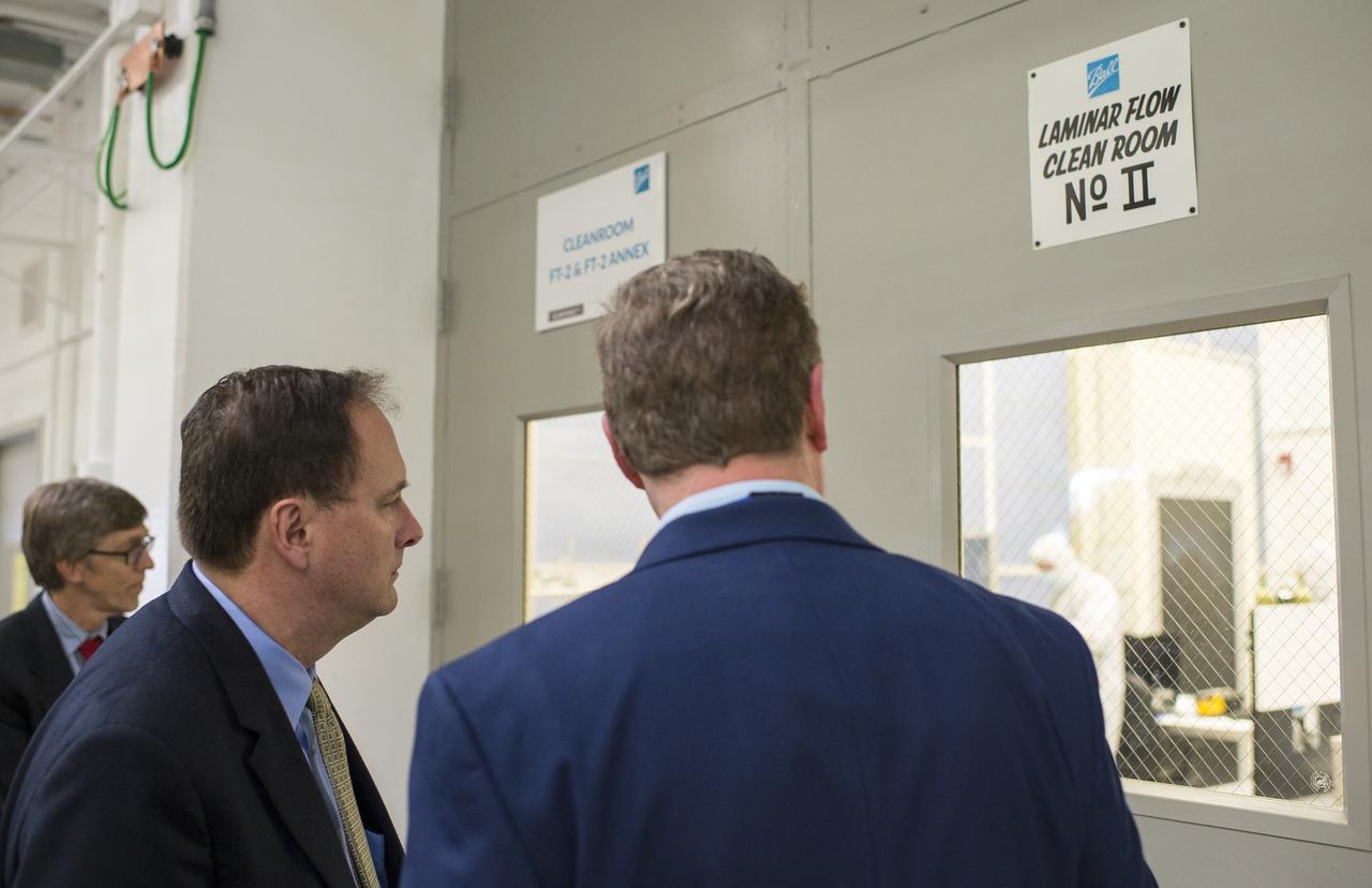 Acting NASA Administrator Robert Lightfoot, left, views a clean room with Tim Schoenweis, senior project engineer for the Ozone Mapping Profiler Suite (OMPS) at Ball Aerospace, right, Thursday, April 6, 2017 at Ball Aerospace in Boulder, Colo. Photo Credit: (NASA/Joel Kowsky)