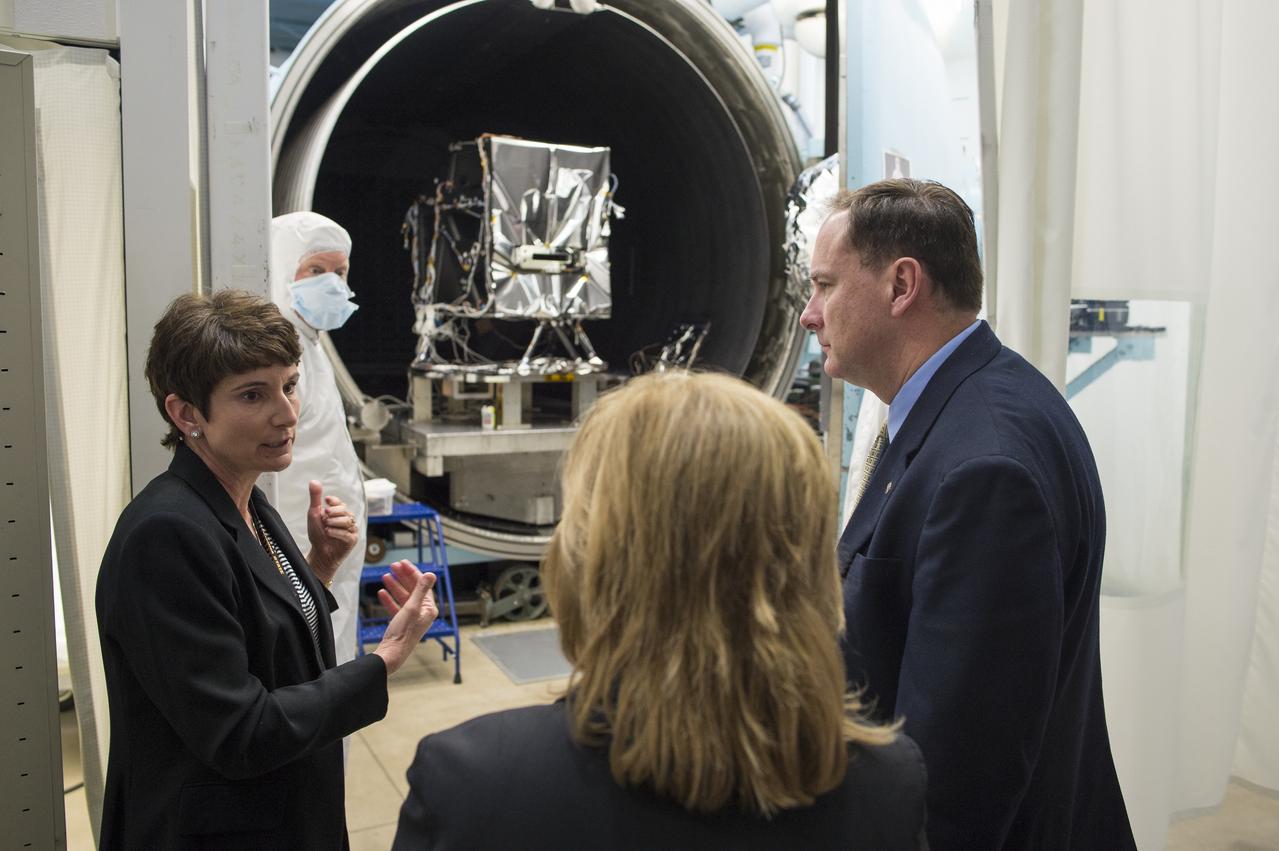 Leanne Presley, Operational Land Imager-2 (OLI-2) program manager at Ball Aerospace, left, speaks with acting NASA Deputy Administrator Lesa Roe, center, and acting NASA Administrator Robert Lightfoot in front of a thermal vacuum chamber used to test satellite optics, Thursday, April 6, 2017 during a visit to Ball Aerospace in Boulder, Colo. The Operation Land Imager-2 (OLI-2) is being build for Landsat 9, a collaboration between NASA and the U.S. Geological Survey that will continue the Landsat Program's 40-year data record of monitoring the Earth's landscapes from space.  Photo Credit: (NASA/Joel Kowsky)