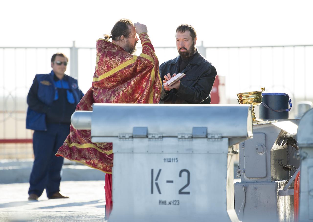 An Orthodox priest blesses the Soyuz rocket at the Baikonur Cosmodrome launch pad on Wednesday, April 19, 2017 in Kazakhstan. Launch of the Soyuz rocket is scheduled for April 20 Baikonur time and will carry Expedition 51 Soyuz Commander Fyodor Yurchikhin of Roscosmos and Flight Engineer Jack Fischer of NASA into orbit to begin their four and a half month mission on the International Space Station. Photo Credit: (NASA/Aubrey Gemignani)