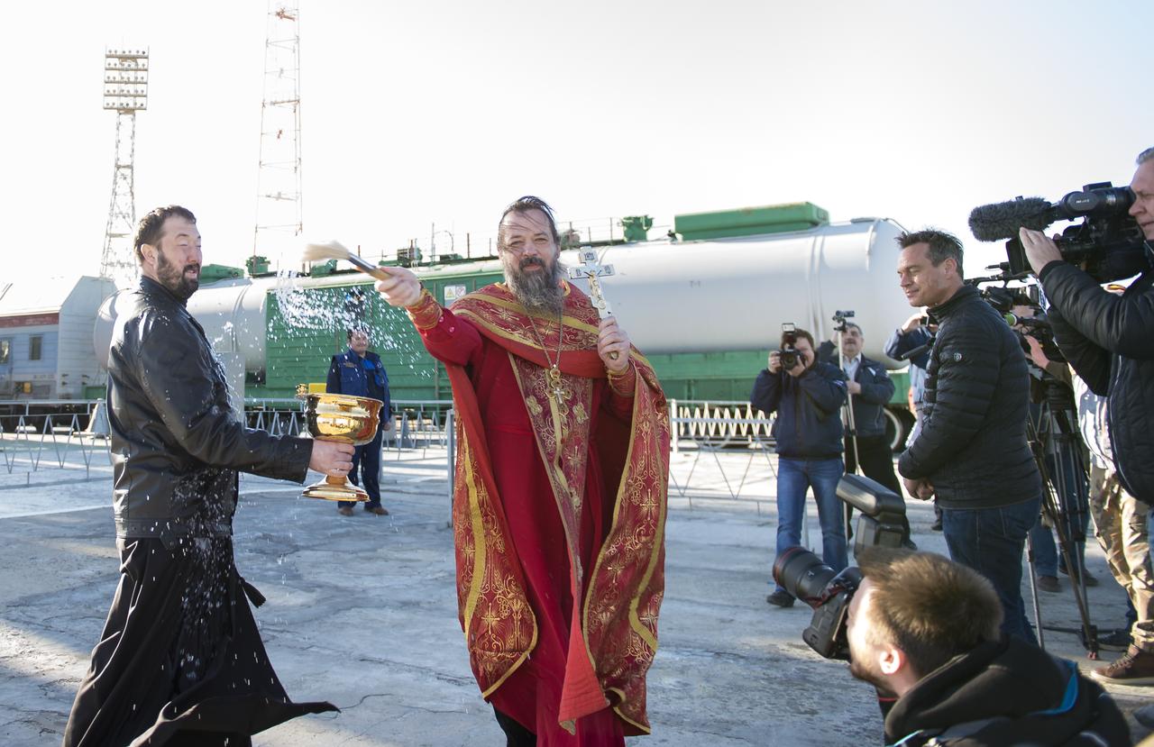 An Orthodox priest blesses the media at the Baikonur Cosmodrome launch pad on Wednesday, April 19, 2017 in Kazakhstan. Launch of the Soyuz rocket is scheduled for April 20 Baikonur time and will carry Expedition 51 Soyuz Commander Fyodor Yurchikhin of Roscosmos and Flight Engineer Jack Fischer of NASA into orbit to begin their four and a half month mission on the International Space Station. Photo Credit: (NASA/Aubrey Gemignani)