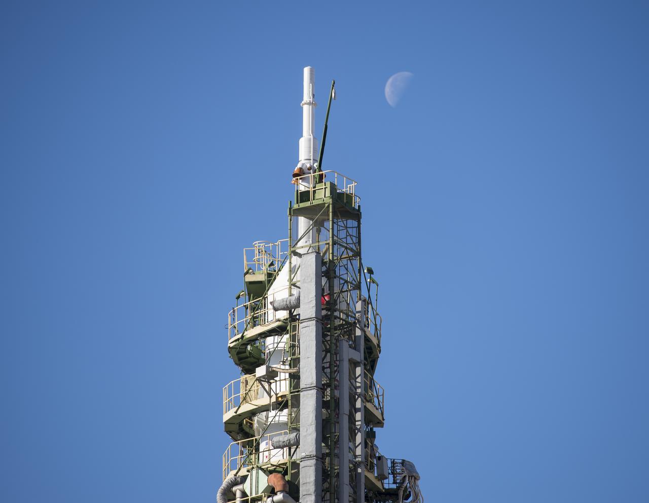 The moon is seen behind the Soyuz MS-04 spacecraft at the Baikonur Cosmodrome launch pad on Wednesday, April 19, 2017 in Kazakhstan. Launch of the Soyuz rocket is scheduled for April 20 Baikonur time and will carry Expedition 51 Soyuz Commander Fyodor Yurchikhin of Roscosmos and Flight Engineer Jack Fischer of NASA into orbit to begin their four and a half month mission on the International Space Station. Photo Credit: (NASA/Aubrey Gemignani)