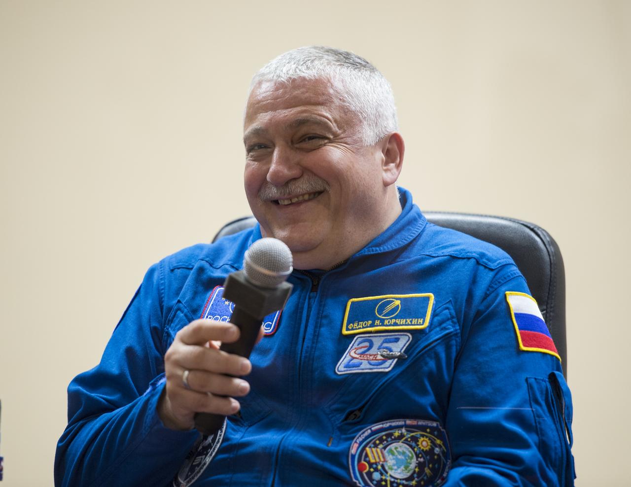 Expedition 51 Soyuz Commander Fyodor Yurchikhin of Roscosmos reacts after answering a question during a pre-launch press conference on Wednesday, April 19, 2017 at the Cosmonaut Hotel in Baikonur, Kazakhstan. Launch of the Soyuz rocket is scheduled for April 20 and will carry Yurchikhin and Flight Engineer Jack Fischer of NASA into orbit to begin their four and a half month mission on the International Space Station. Photo Credit: (NASA/Aubrey Gemignani).