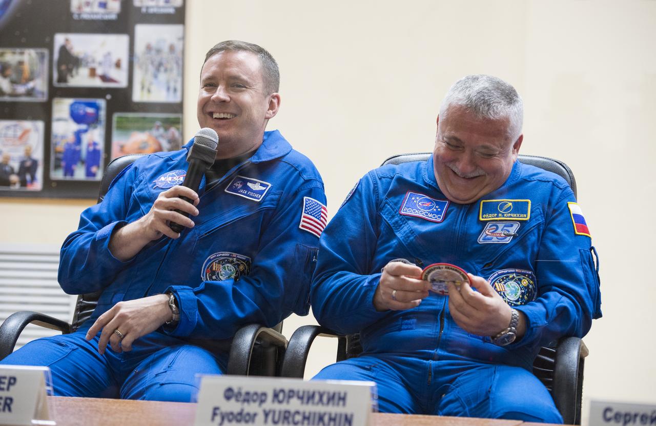 Expedition 51 Soyuz Commander Fyodor Yurchikhin of Roscosmos, right, reacts as crew mate Flight Engineer Jack Fischer of NASA, left, answers a question during a press conference on Wednesday, April 19, 2017 at the Cosmonaut Hotel in Baikonur, Kazakhstan. Launch of the Soyuz rocket is scheduled for April 20 and will carry Yurchikhin and Fischer into orbit to begin their four and a half month mission on the International Space Station. Photo Credit: (NASA/Aubrey Gemignani).