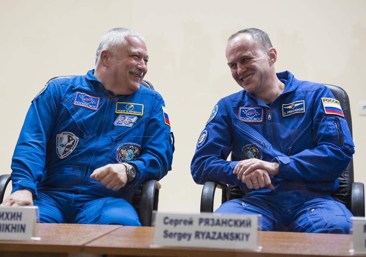 Expedition 51 prime crew member Soyuz Commander Fyodor Yurchikhin of Roscosmos, left, laughs with Expedition 51 backup crew member Sergey Ryazanskiy of Roscosmos during a press conference on Wednesday, April 19, 2017 at the Cosmonaut Hotel in Baikonur, Kazakhstan. Launch of the Soyuz rocket is scheduled for April 20 and will carry Yurchikhin and Flight Engineer Jack Fischer of NASA into orbit to begin their four and a half month mission on the International Space Station. Photo Credit: (NASA/Aubrey Gemignani).