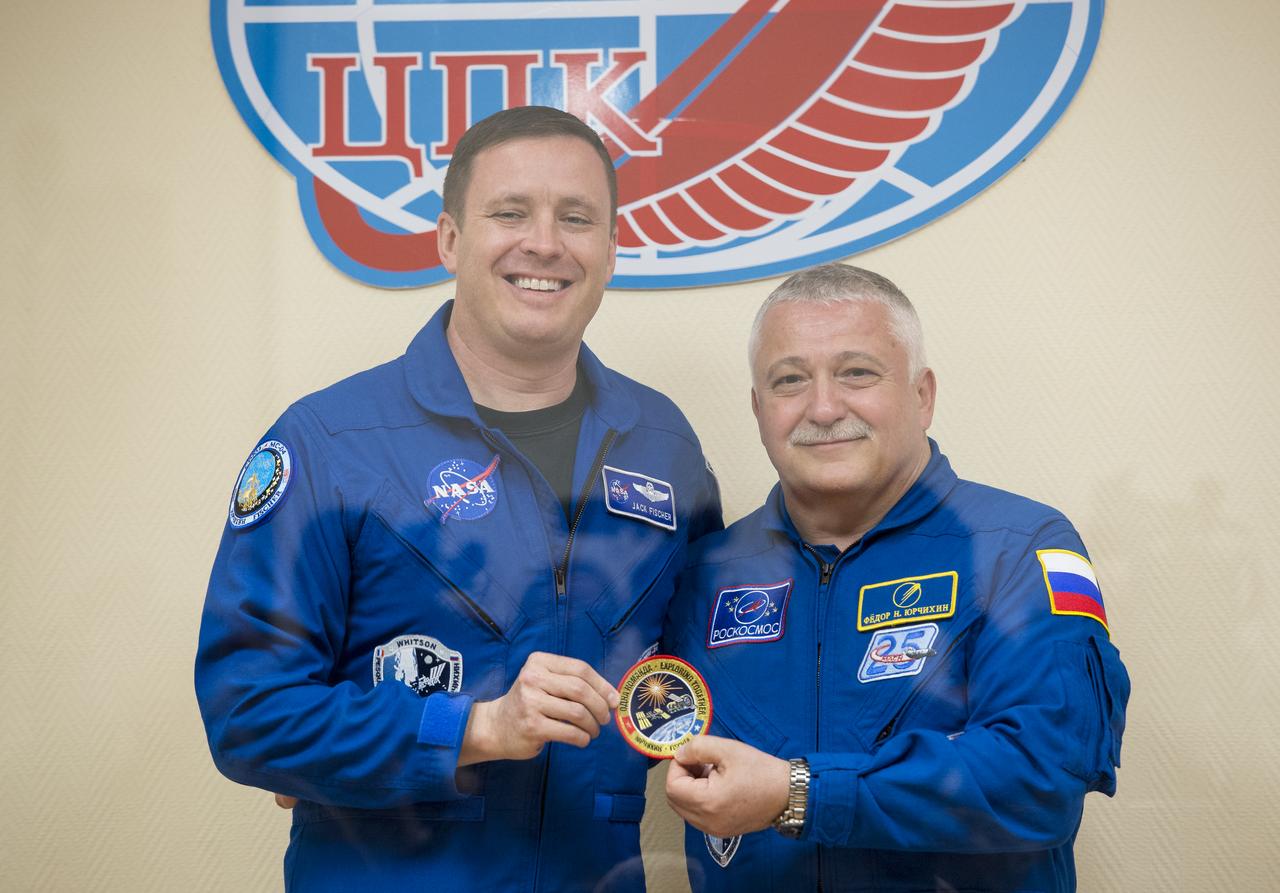 Expedition 51 Flight Engineer Jack Fischer of NASA, left, poses for a photo with Soyuz Commander Fyodor Yurchikhin of Roscosmos, right, at the conclusion of a pre-launch press conference on Wednesday, April 19, 2017 at the Cosmonaut Hotel in Baikonur, Kazakhstan. Launch of the Soyuz rocket is scheduled for April 20 and will carry Yurchikhin and Fischer into orbit to begin their four and a half month mission on the International Space Station. Photo Credit: (NASA/Aubrey Gemignani).
