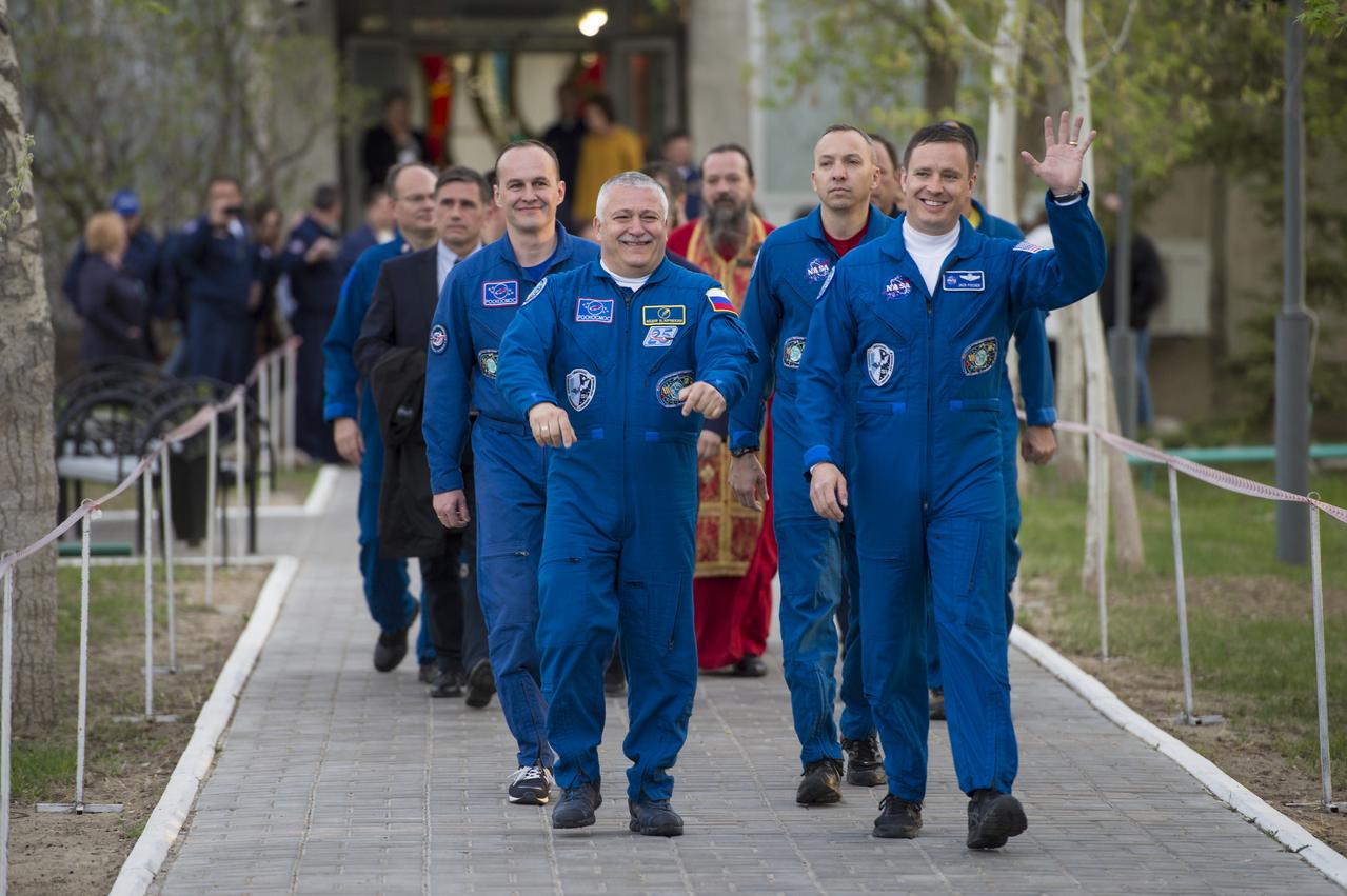 Expedition 51 crew members, Soyuz Commander Fyodor Yurchikhin of Roscosmos, left, and Flight Engineer Jack Fischer of NASA, right, wave to family and friends as they depart the Cosmonaut Hotel to suit-up for their Soyuz launch to the International Space Station on Thursday, April 20, 2017 in Baikonur, Kazakhstan. Launch of the Soyuz rocket is scheduled for 1:13PM April 20 Baikonur time and will send Yurchikhin and Fischer on a four and a half month mission aboard the International Space Station. Photo Credit: (NASA/Aubrey Gemignani)