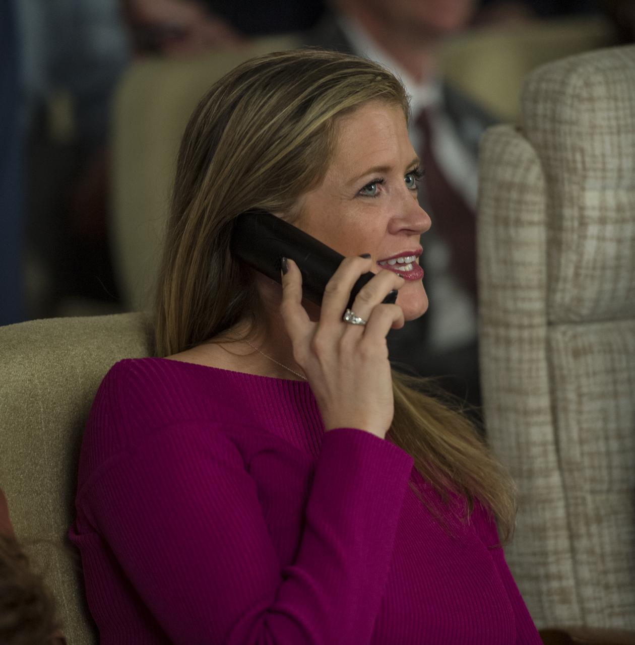 Elizabeth Fischer, wife of Expedition 51 Flight Engineer Jack Fischer of NASA, speaks to him by phone a few hours after his Soyuz MS-04 spacecraft docked to the International Space Station (ISS) on Thursday, April 20, 2017 at Tsenki Conference Hall in Baikonur, Kazakhstan. Soyuz Commander Fyodor Yurchikhin of Roscosmos and Fischer's arrival to ISS comes the same day they launched from the Baikonur Cosmodrome in Kazakhstan. Photo Credit (NASA/Aubrey Gemignani)