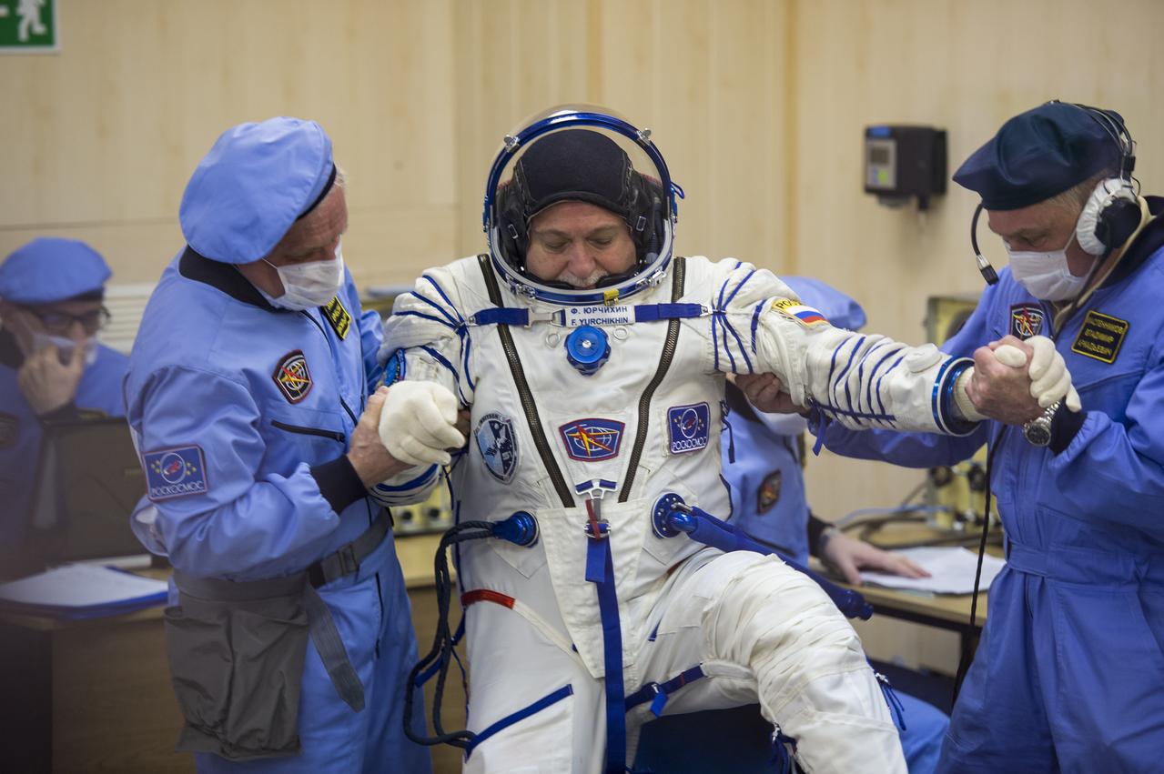 Expedition 51 Soyuz Commander Fyodor Yurchikhin of Roscosmos is helped up after having his Russian Sokol suit pressure checked in preparation for launch aboard the Soyuz MS-04 spacecraft on Thursday, April 20, 2017, at the Baikonur Cosmodrome in Kazakhstan. Launch of the Soyuz rocket is scheduled for 1:13pm April 20 Baikonur time, and will carry Yurchikhin and fellow crewmate, Flight Engineer Jack Fischer of NASA into orbit to begin their four and a half month mission on the International Space Station. Photo Credit: (NASA/Aubrey Gemignani)