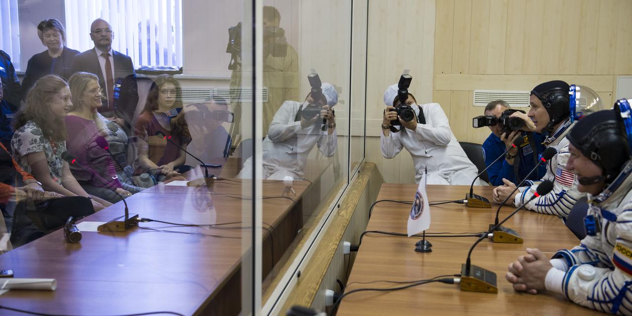 Expedition 51 Flight Engineer Jack Fischer of NASA, top, and Soyuz Commander Fyodor Yurchikhin of Roscosmos, bottom, speak with family after having their Russian Sokol suits pressure checked in preparation for launch onboard the Soyuz MS-04 spacecraft on Thursday, April 20, 2017 at the Baikonur Cosmodrome in Kazakhstan. The Soyuz spacecraft with Fischer and Yurchikhin is scheduled to launch at 1:13pm Baikonur time on April 20. Photo Credit: (NASA/Aubrey Gemignani)