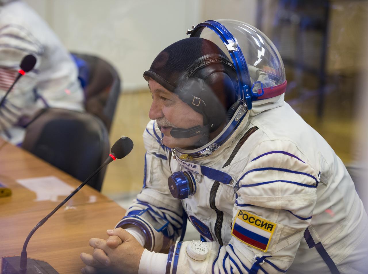 Expedition 51 Soyuz Commander Fyodor Yurchikhin of Roscosmos speaks with his family after having his Russian Sokol suit pressure checked in preparation for launch onboard the Soyuz MS-04 spacecraft on Thursday, April 20, 2017 at the Baikonur Cosmodrome in Kazakhstan. The Soyuz spacecraft with Yurchikhin and Flight Engineer Jack Fischer of NASA is scheduled to launch at 1:13pm Baikonur time on April 20. Photo Credit: (NASA/Aubrey Gemignani)