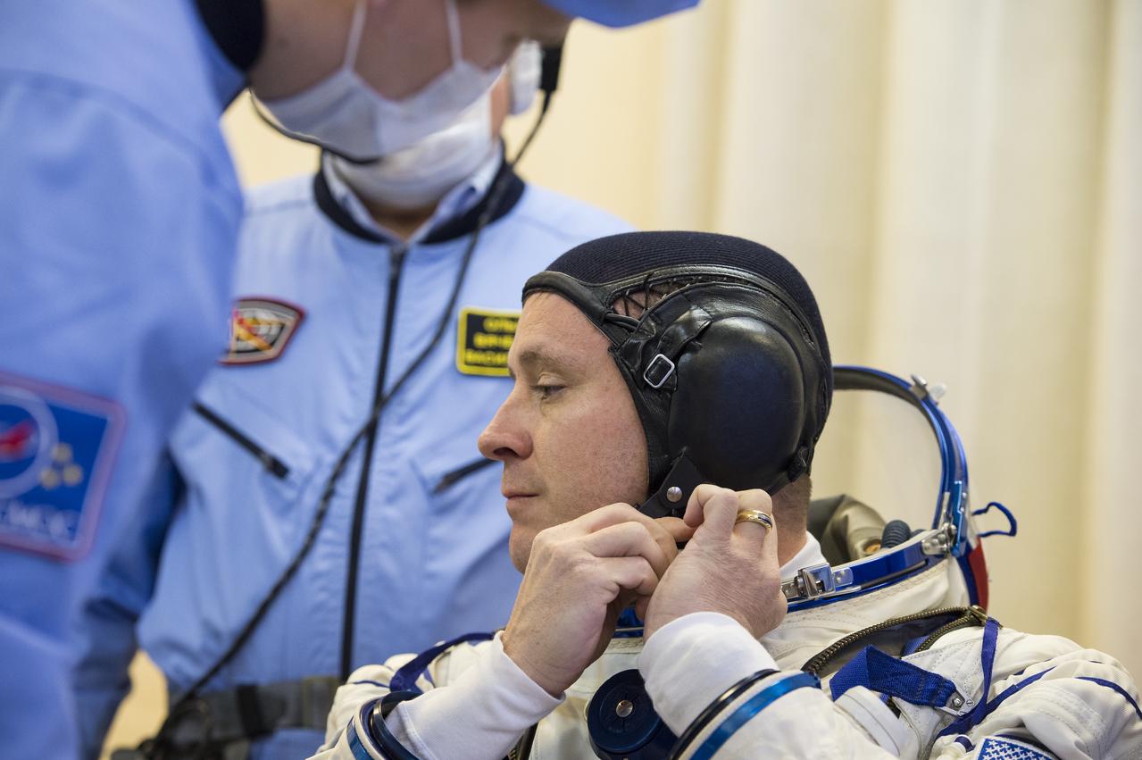 Expedition 51 Flight Engineer Jack Fischer of NASA is helped into his Russian Sokol suit as he and fellow crewmate, Soyuz Commander Fyodor Yurchikhin of Roscosmos prepare for their Soyuz launch to the International Space Station, Thursday, April 20, 2017 at the Baikonur Cosmodrome in Kazakhstan. Launch of the Soyuz rocket is scheduled for 1:13pm April 20 Baikonur time, and will carry Fischer and Yurchikhin into orbit to begin their four and a half month mission on the International Space Station. Photo Credit: (GCTC/Andrey Shelepin)